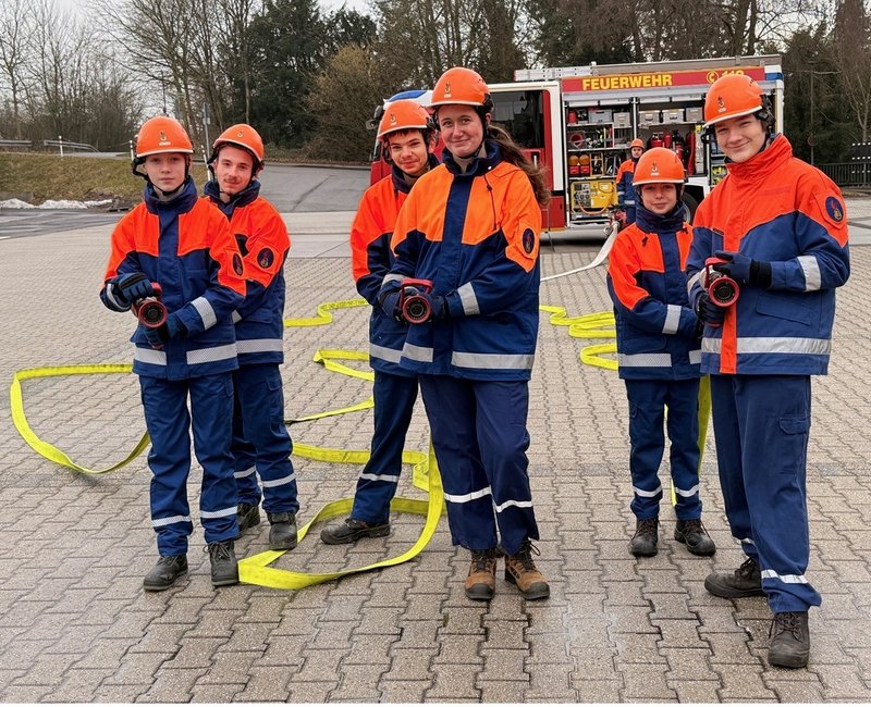 Jugendfeuerwehrleute mit Löschschläuchen